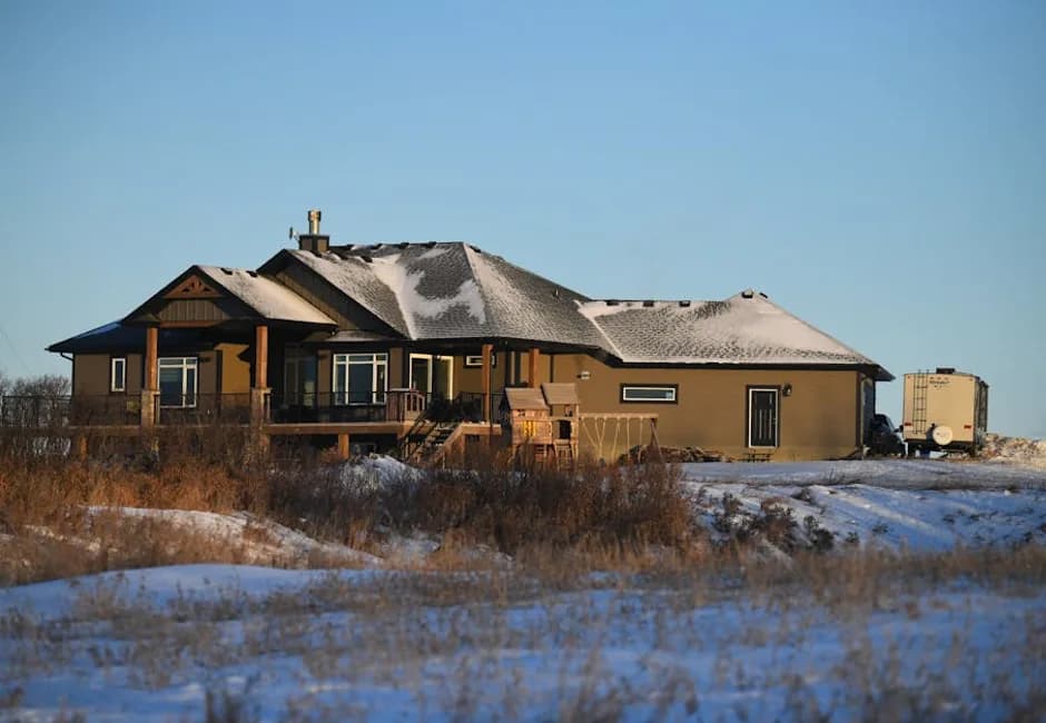 Snow-covered house in an Ontario winter cold climate heat pumps keep homes warm at -30°C