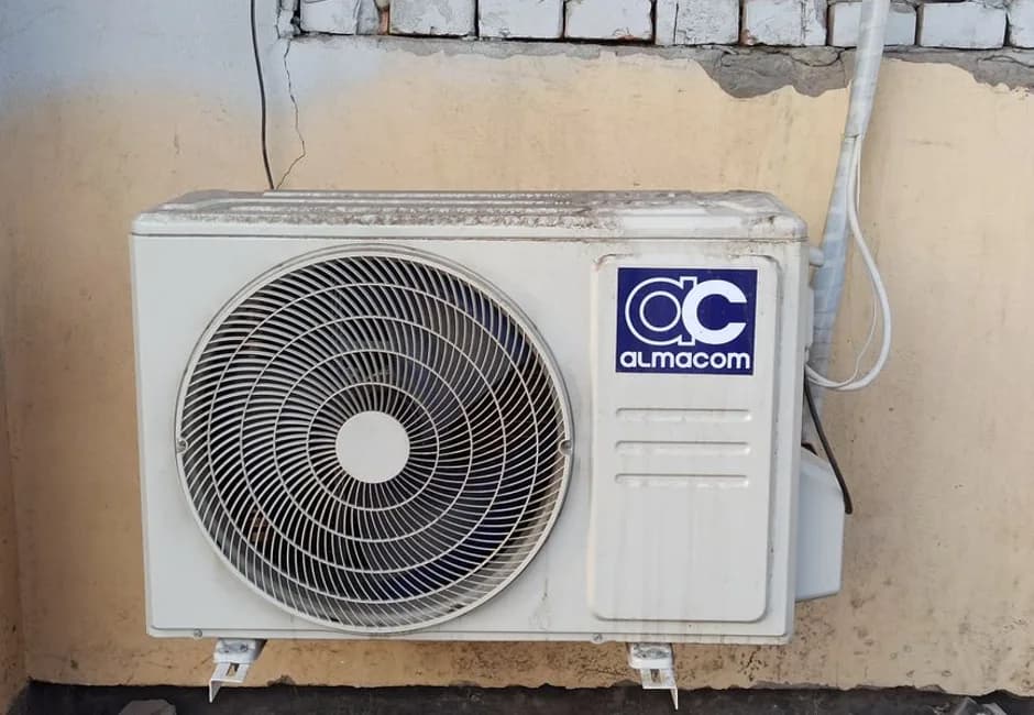 Outdoor central air conditioning unit installed beside a brick home in Mississauga