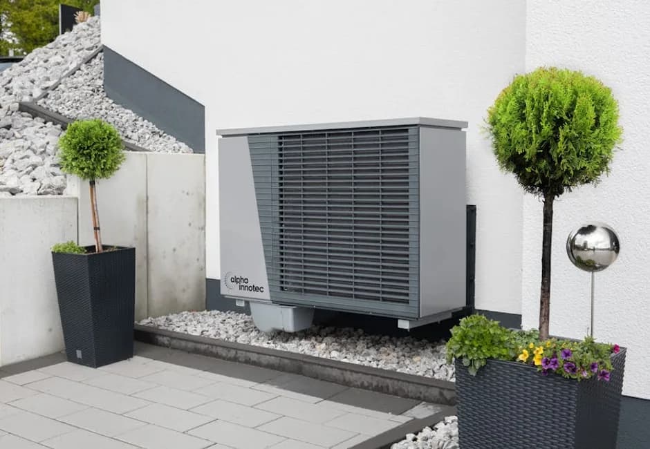 Outdoor heat pump unit integrated into a landscaped Ontario home exterior