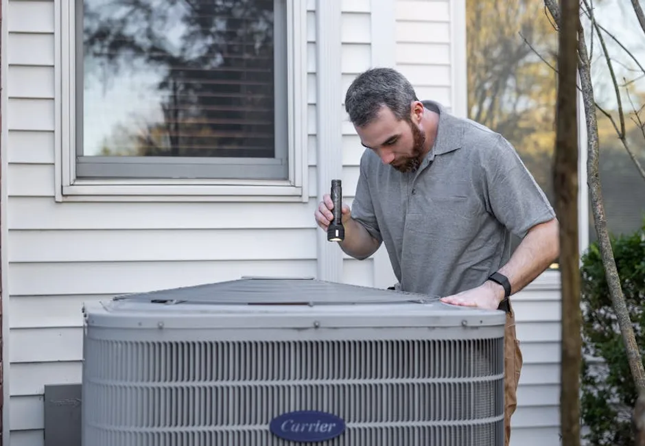 HVAC technician inspecting an outdoor unit furnace vs heat pump comparison for Ontario homes