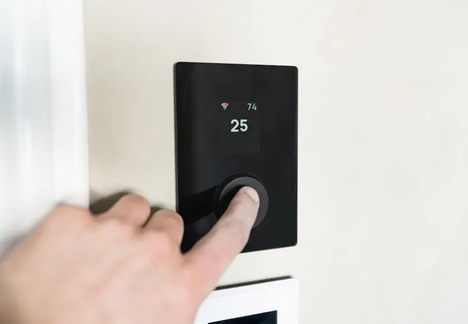 Homeowner adjusting a modern smart thermostat on a wall in a Mississauga home