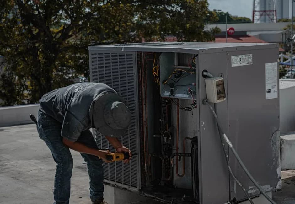 HVAC technician completing a new furnace installation in a residential basement