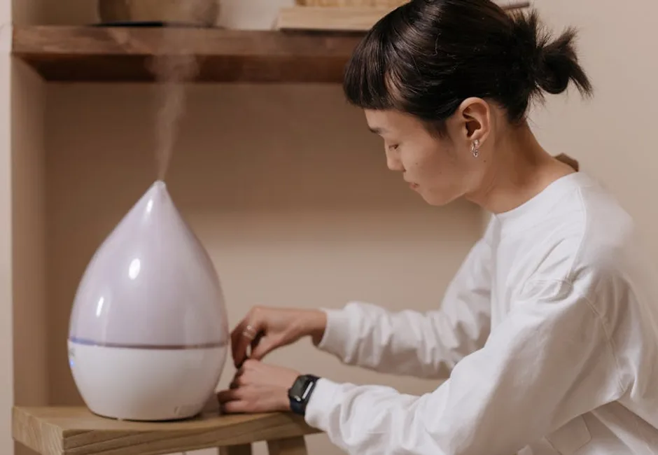 Woman adjusting a whole-home humidifier control panel in a Toronto home during winter